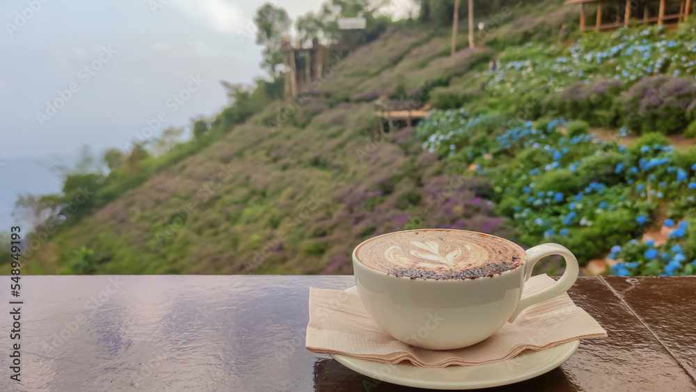 Hot coffee in white cup and blurred nature background. Hot coffee in white cup and blurred nature background.