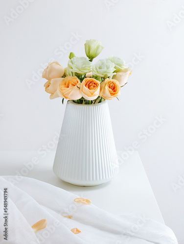roses were laid on a white table