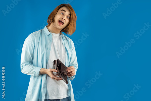 Fotografie Emotional young man with empty wallet