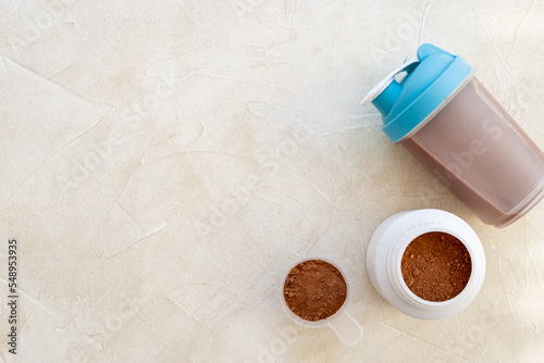 Whey protein powder in jar with shaker for mixing. Fitness and gym diet