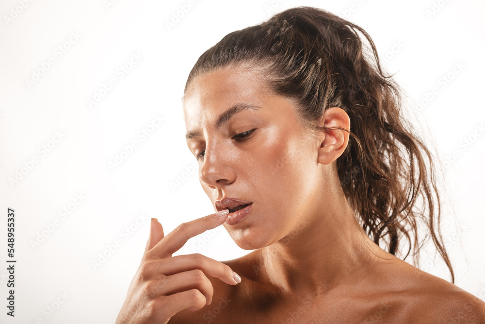 Close up of a model posing with her finger on her lip Close up of a model posing with her finger on her lip