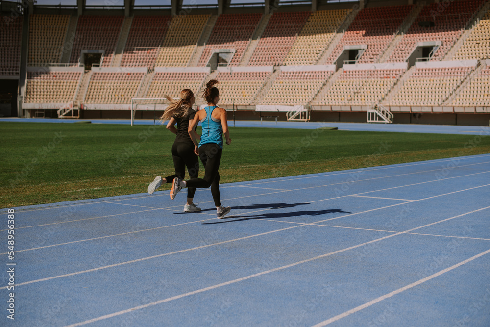 Two girls running at the stadium