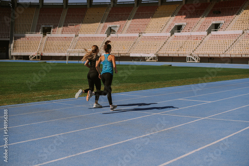 Two girls running at the stadium