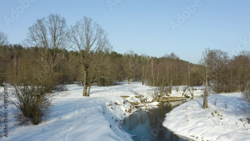 rone shot flying on winter river. Frozen river at sunny winter day. photo