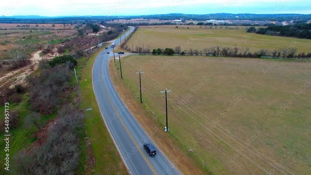 Aerial Shot Of Cars And Tour Bus Moving On Road, Drone Flying Forward Over Natural Landscape - San Antonio, Texas Aerial Shot Of Cars And Tour Bus Moving On Road, Drone Flying Forward Over Natural Landscape - San Antonio, Texas