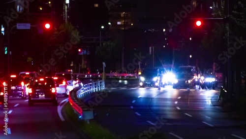 A night timelapse of the traffic jam at the downtown street in Tokyo long shot zoom photo