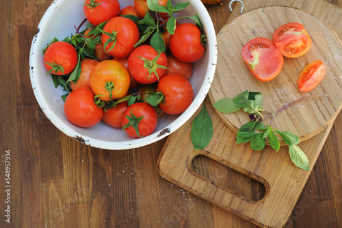 Ripe organic tomatoes in white bowl, top view