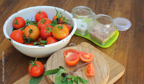 Ripe organic tomatoes in white bowl