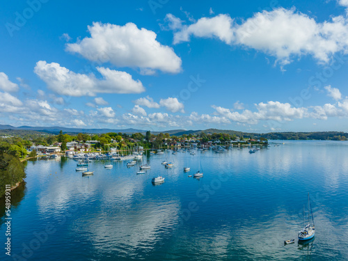 Photography Morning waterfront views with clouds, boats and the blue lake water