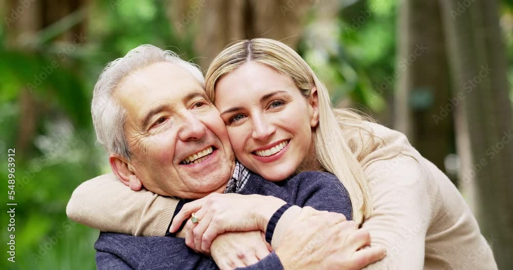 Family, disability and woman hugging her senior man father in the park during a summer day together. Love, hug and wheelchair with a mature male and adult daughter bonding in the first or woods Family, disability and woman hugging her senior man father in the park during a summer day together. Love, hug and wheelchair with a mature male and adult daughter bonding in the first or woods
