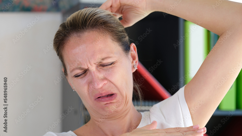 Female sniffing armpits and feeling of revulsion because of smell Female sniffing armpits and feeling of revulsion because of smell