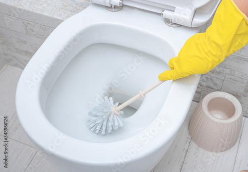 cleaning wc. Housekeeper, cleaning man at toilet. Brush up Toilet for cleanliness and hygiene. cleaning toilet bowl. Cleaning service concept photo