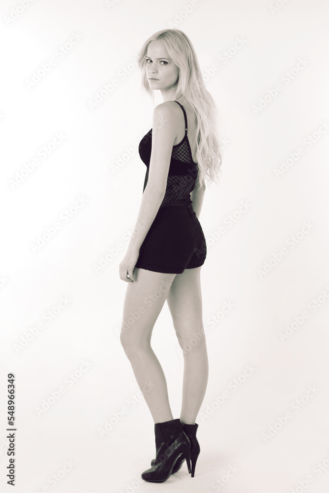 Fashion, beauty and portrait with a woman in studio on a mockup space white studio background. High heels, monochrom and style with a young female model posing for a contemporary or elegant style Fashion, beauty and portrait with a woman in studio on a mockup space white studio background. High heels, monochrom and style with a young female model posing for a contemporary or elegant style