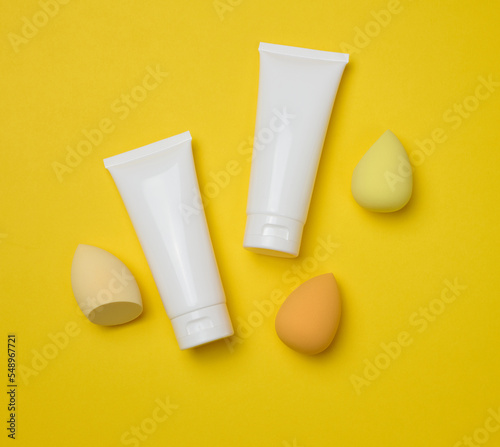 Wallpaper Mural White plastic tubes for cream, gel and other cosmetics and sponges on a yellow background Torontodigital.ca