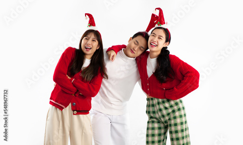 Young asian people group in red and white color clothes christmas theme posing laughing on white background. Merry Christmas.