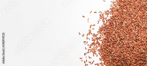 Uncooked Red Rice Wallpaper. Long Brown Rice Rotating. Close Up. Grains fall poured a stack. World crisis, export, import. Harvest problems, sanctions. Increase prices and shortages of food supplies