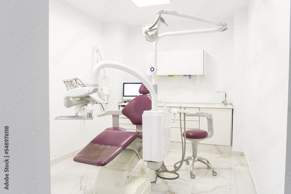 Modern pink dental clinic, dentist chair and other accessories used by dentists. The dental surgeon is a surgeon who specializes in dentistry and treatment of diseases of the oral cavity. Modern pink dental clinic, dentist chair and other accessories used by dentists. The dental surgeon is a surgeon who specializes in dentistry and treatment of diseases of the oral cavity.