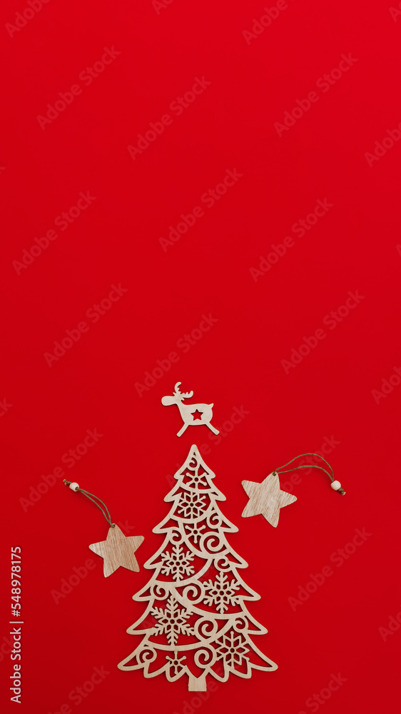 wooden decorative decoration of fir-tree, star and deer on red background, vertical, 16:9 wooden decorative decoration of fir-tree, star and deer on red background, vertical, 16:9