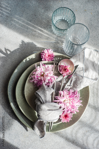Overhead view of a formal place setting decorated with pink chrysanthemum flowers