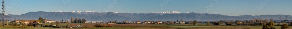 Panoramic view of the partially snow-capped Apennines from the Tuscan countryside near Bientina, Pisa , Italy
