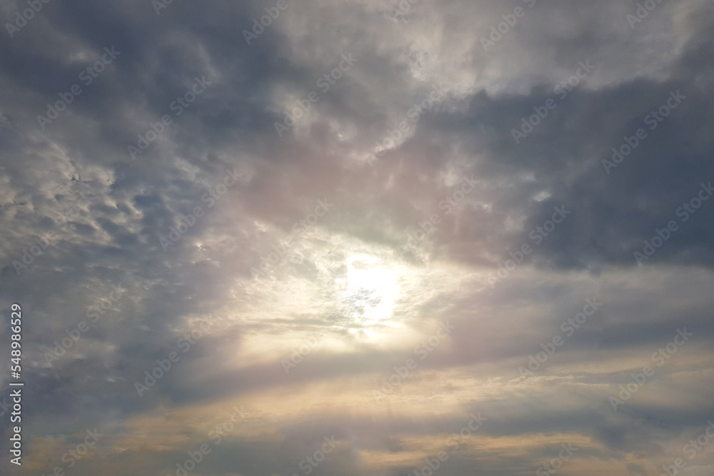 Obraz premium Sun against grey storm clouds