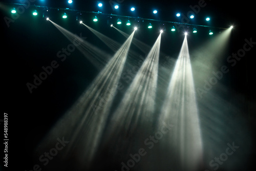Blue and white concert stage show party lights on black background