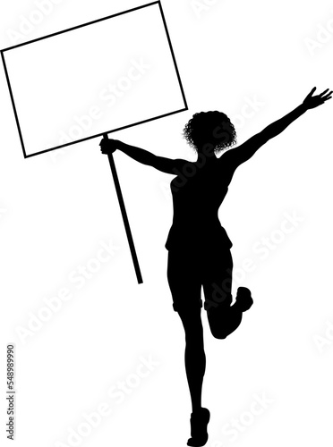 Protestor or demonstrator at a demonstration march, picket line or strike protest rally in silhouette. Holding up a banner or picket sign board placard.