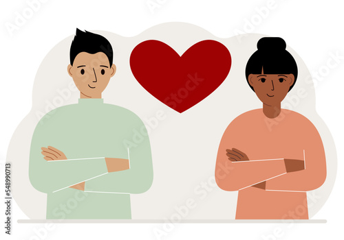 Happy man and woman next to a big red heart. Love.