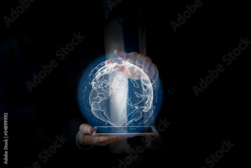 Businessman holding holographic image of the Earth. Science and technology concept.