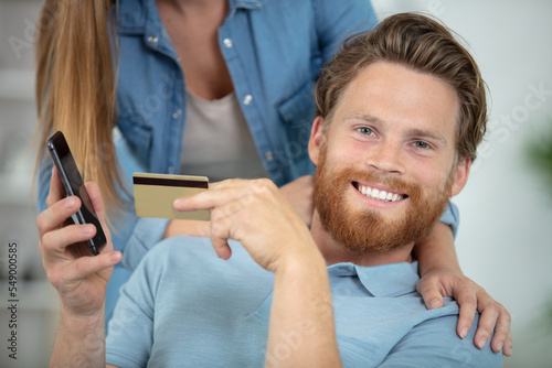man shopping online with credit card and mobile phone photo