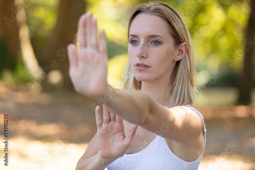 woman practicing tai chi quan in the park photo