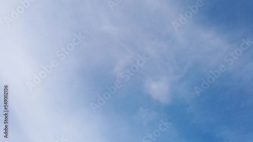 White fluffy and beautiful cumulus clouds like a cotton  freedom smooth tranform like sea wave shape on blue sky  in daytime beauty in  nature top view tropical  time lapse