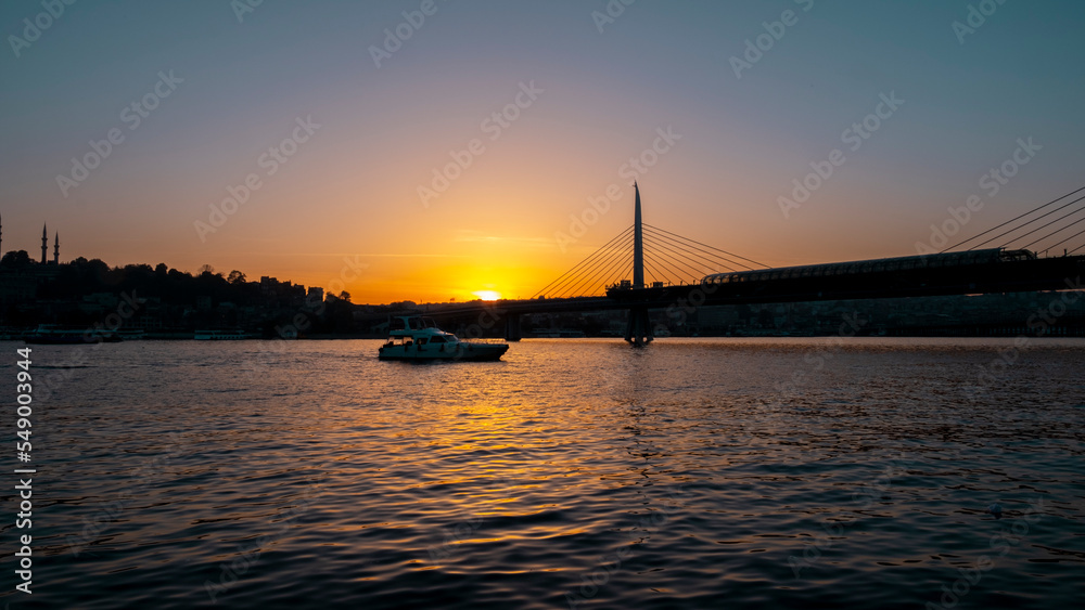 Beautiful sunset, Golden hours, Golden Horn metro bridge and the view of the Golden Horn in Istanbul, the sunset, the birds heading towards the sun, The image with space and text area. Beautiful sunset, Golden hours, Golden Horn metro bridge and the view of the Golden Horn in Istanbul, the sunset, the birds heading towards the sun, The image with space and text area.