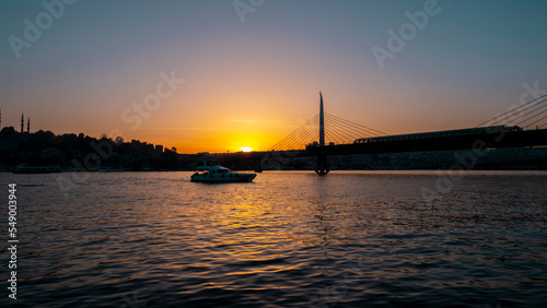 Beautiful sunset, Golden hours, Golden Horn metro bridge and the view of the Golden Horn in Istanbul, the sunset, the birds heading towards the sun, The image with space and text area.