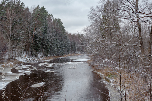 Frosty scene at the river Liela Jugla with snow and ice in late November in Bajari in Latvia photo