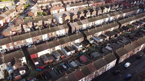 Congested North West UK suburban property estate aerial view Birdseye over townhouse rooftops