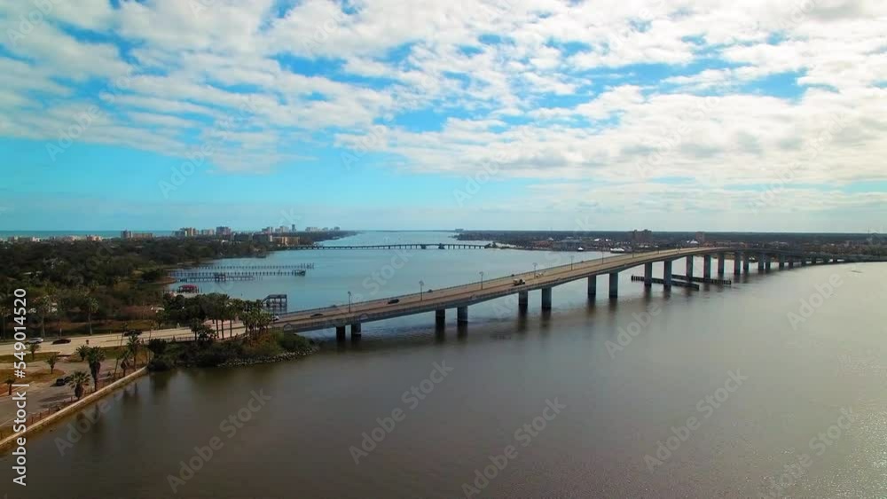 Aerial Beautiful View Of Bridges And Piers In City, Drone Flying Forward Over Sea Under Clouds - Daytona Beach, Florida Aerial Beautiful View Of Bridges And Piers In City, Drone Flying Forward Over Sea Under Clouds - Daytona Beach, Florida