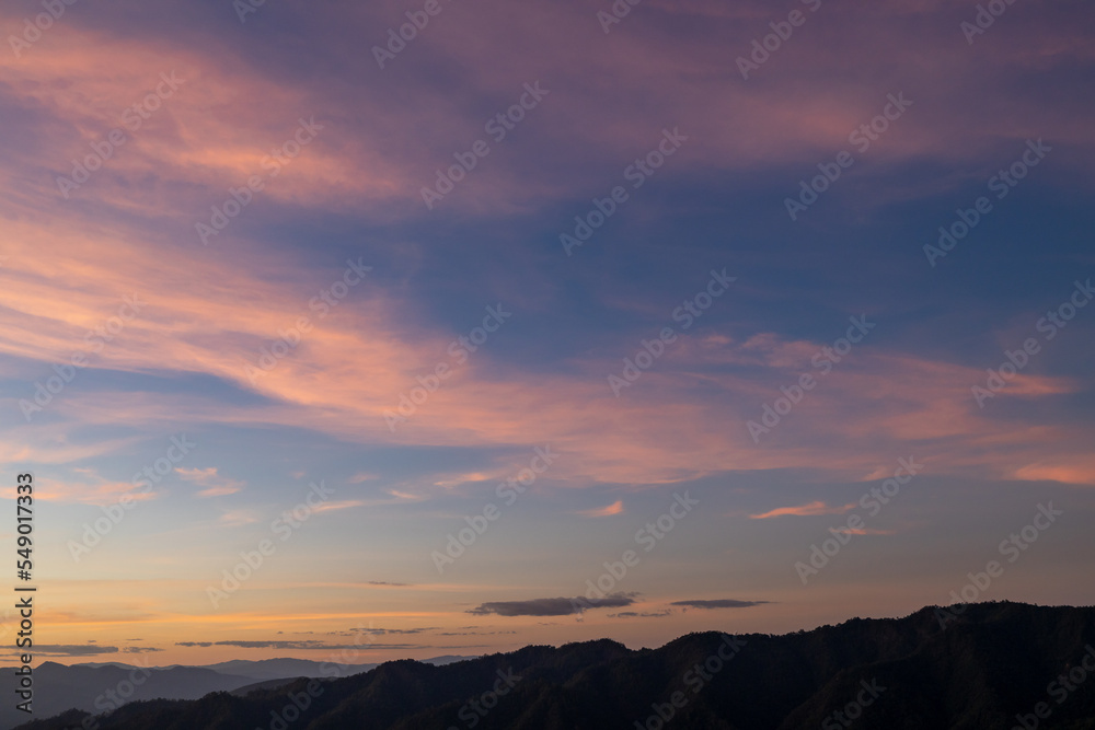  Sunset with clouds on the mountains.The sunset gives pass through the clouds late evening. Ray of the sunset with sky background. Beautiful sun beam pass through the cloud. Beautiful sky.