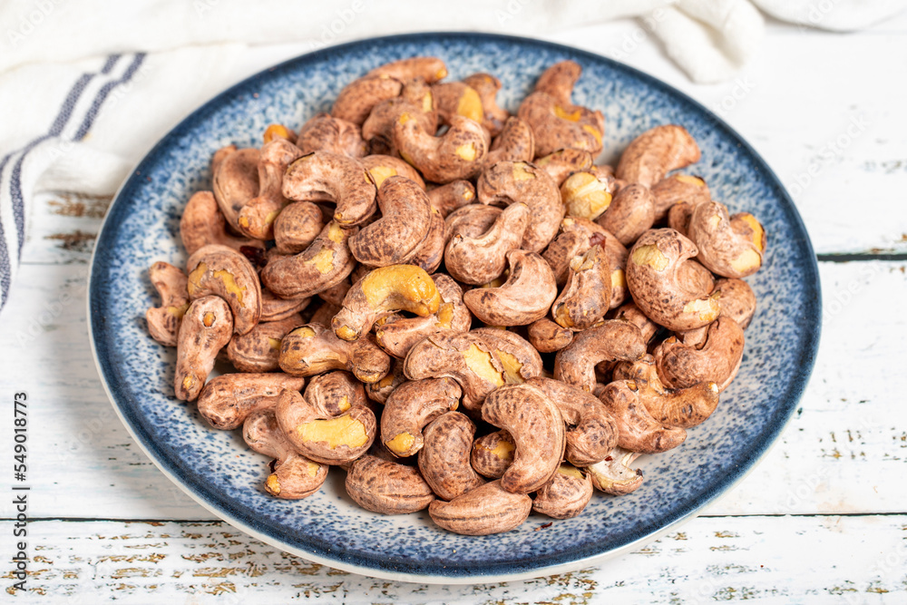 Cashew nuts on wood background. Raw cashews. Healthy food. close up Cashew nuts on wood background. Raw cashews. Healthy food. close up
