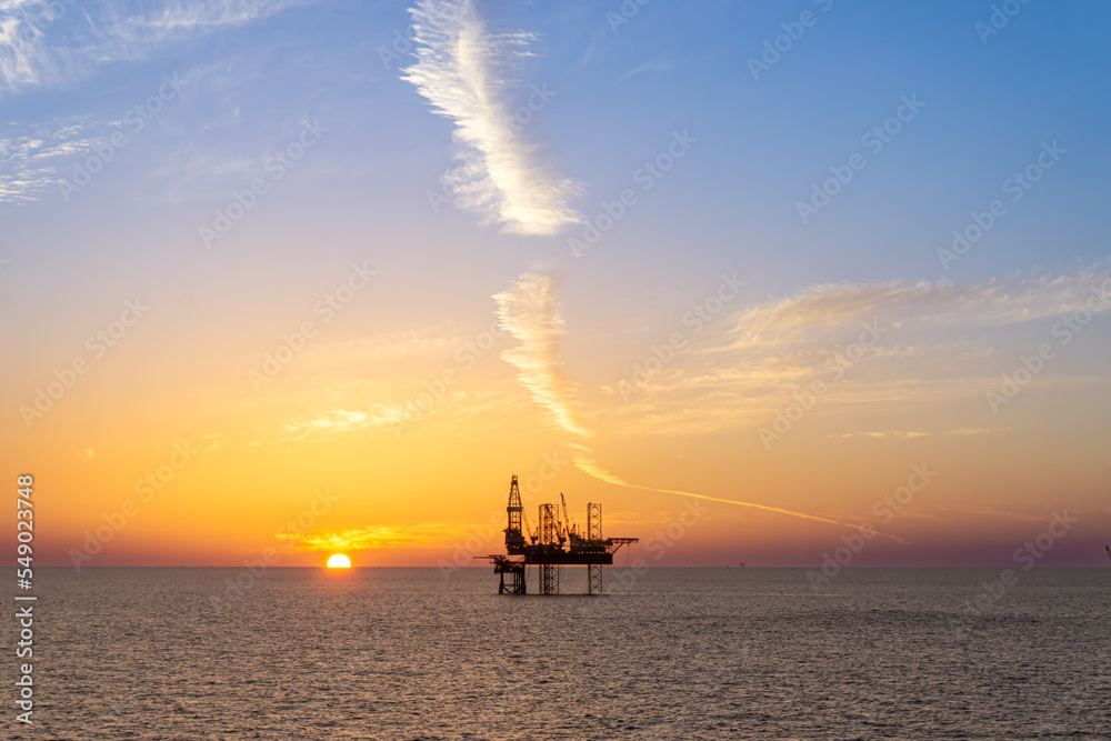 Silhouette, Offshore Jack Up Rig in The Middle of The Sea at Sunset Time