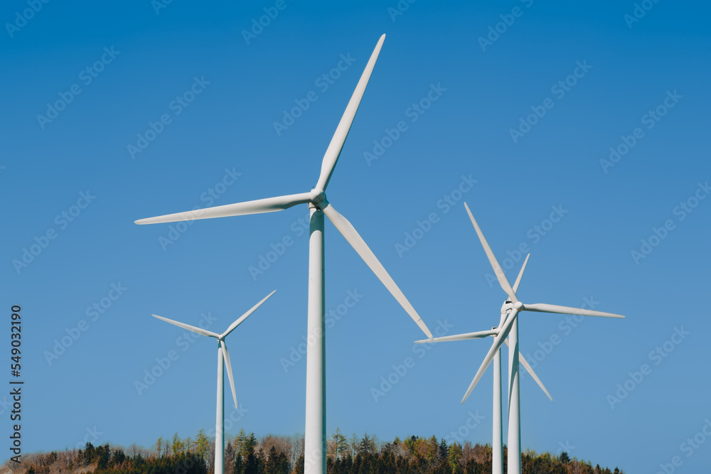 wind turbines in sunlight under the blue sky wind turbines in sunlight under the blue sky