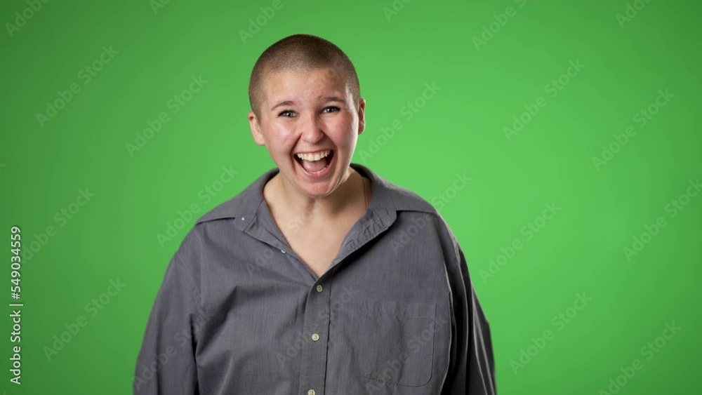 Pretty thinking non binary gender fluid young woman 20s, looks at camera gives mind blown gesture showing explosion of ideas posing on green screen background.
