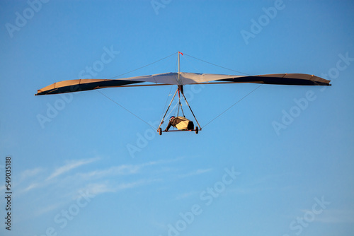 Hang glider flying on sunny day