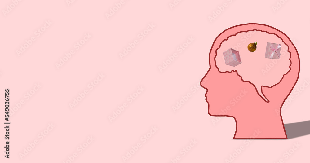 pink head in whose brain is a package from which an ornament falls out, next to the head copy space, pink background, creative art holiday concept
