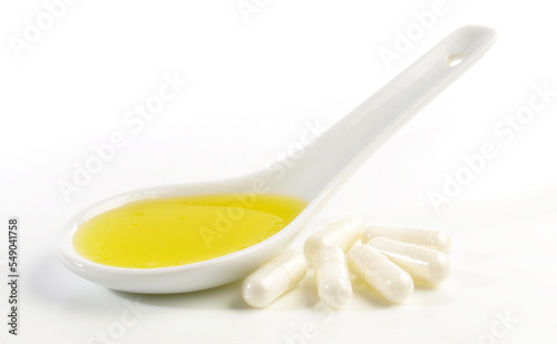 Butyrate Capsules with liquid Butter isolated on white Background photo