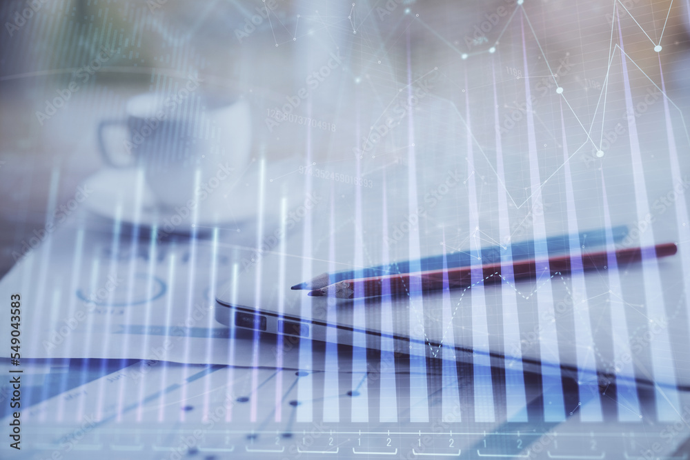 Forex graph hologram on table with computer background. Double exposure. Concept of financial markets. Forex graph hologram on table with computer background. Double exposure. Concept of financial markets.