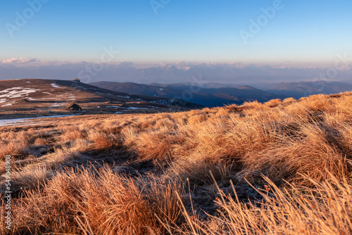 Scenic view of alpine meadows and Karawanks mountains at sunrise seen from Ladinger Spitz, Saualpe, Lavanttal Alps, Carinthia, Austria, Europe. Hiking trails at morning golden hour in Wolfsberg region