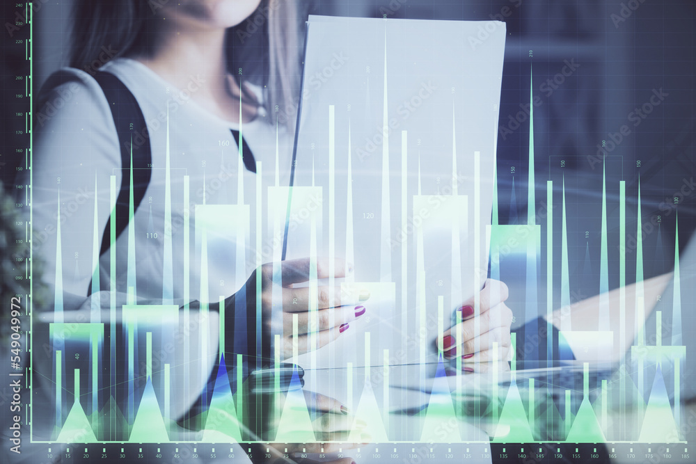 Double exposure of hands making notes with forex chart huds. Stock market concept.