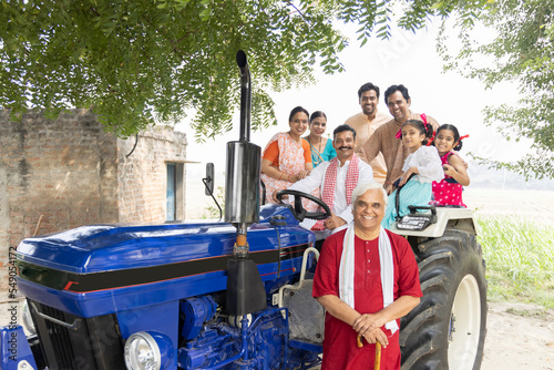 Indian rural people sitting on the tractor