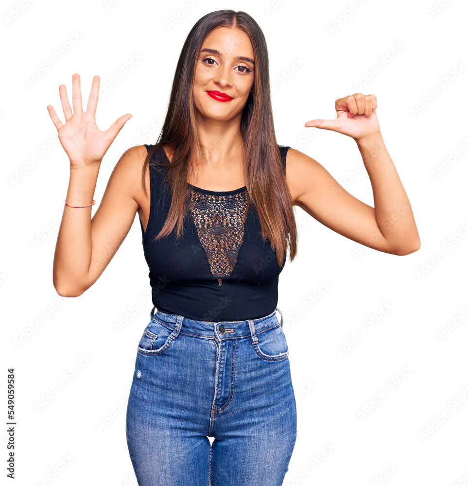 Young hispanic woman wearing casual clothes showing and pointing up with fingers number six while smiling confident and happy. Young hispanic woman wearing casual clothes showing and pointing up with fingers number six while smiling confident and happy.